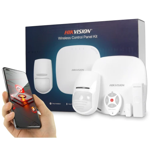 Na zdjęciu znajduje się bezprzewodowy system alarmowy Hikvision, składający się z panelu kontrolnego, czujnika ruchu, syreny i pilota. W tle widoczna jest elegancka, ciemna opakowanie z logo marki, a na pierwszym planie ręka trzymająca smartfon z aplikacją do zarządzania systemem.