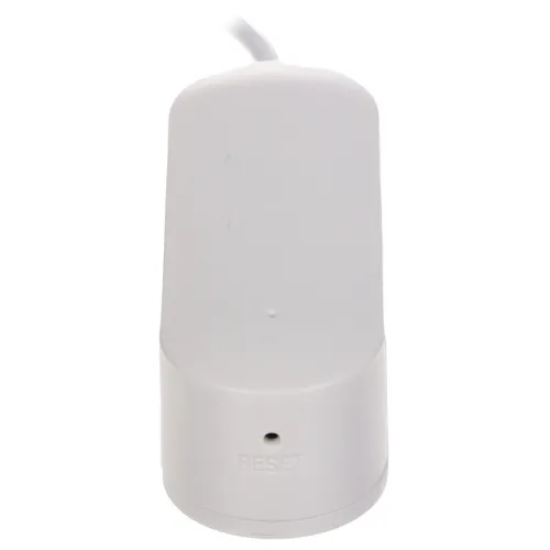 Biały przycisk reset z zaokrąglonymi krawędziami i napisem "RESET" na dole. Przycisk jest podłączony kablem widocznym w górnej części zdjęcia.