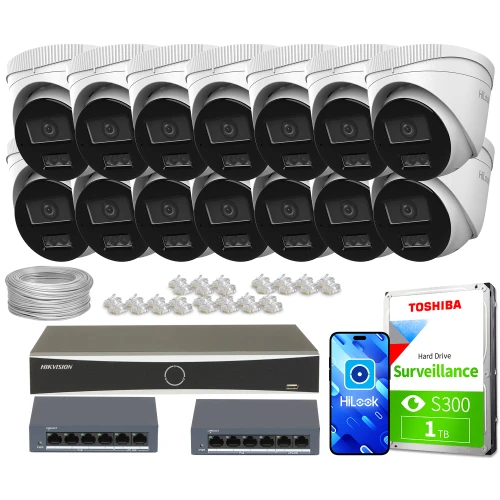 Na zdjęciu znajduje się zestaw do monitoringu, który obejmuje czternaście kamer, dysk twardy Toshiba o pojemności 1TB, dwa switche sieciowe oraz rejestrator Hikvision. Dodatkowo widoczne są przewody i akcesoria montażowe.