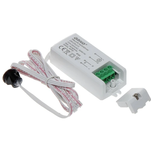 Na zdjęciu znajduje się biały moduł elektroniczny z zielonymi złączami oraz białym przewodem zakończonym czarnym czujnikiem. Obok modułu leży biała plastikowa osłona z metalową śrubą.