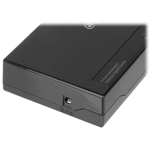 Czarny, prostokątny switch sieciowy z pięcioma portami, posiadający złącze zasilania z boku. Na górnej powierzchni widoczny jest napis "5-Port Unmanaged Desktop Gigabit Switch".